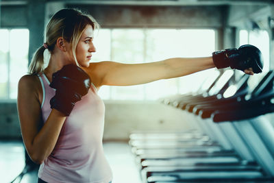 Young woman boxing at gym