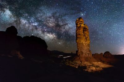 Rock formations against sky at night