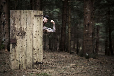 Playing with an old door in the forest