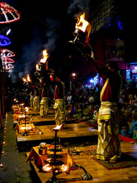 Group of people against illuminated city at night