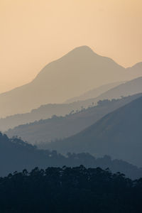 Scenic view of silhouette mountains against sky during sunset