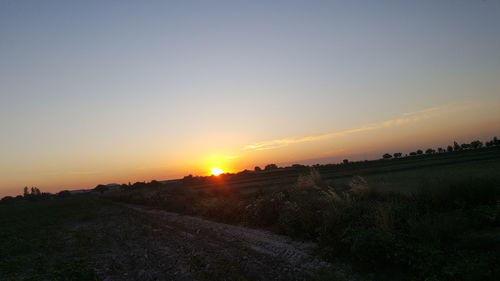 Scenic view of field against sky during sunset