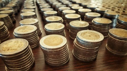 Stacked coins arranged on table