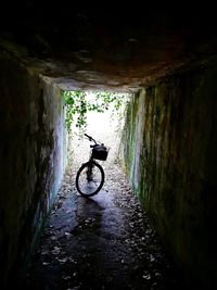 Man riding bicycle in tunnel
