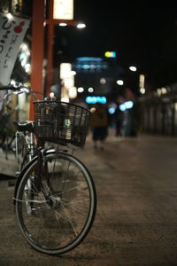 Bicycle in illuminated street at night