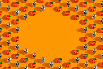 Creative orange pattern made of pumpkin and skull, halloween concept flat flat, top view