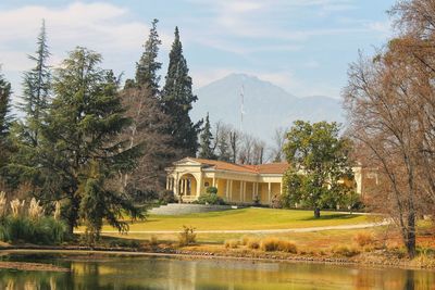 Building by lake with mountain in background