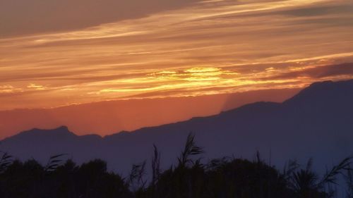 Scenic view of mountains at sunset