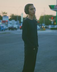 Young man standing on road