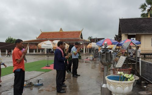 People in town square against sky