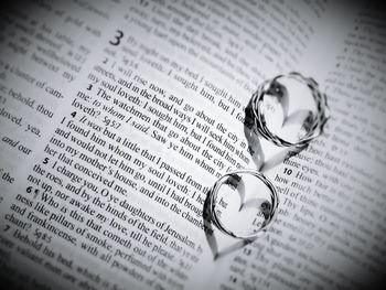 Close-up of wedding rings on open book