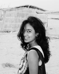 Portrait of smiling young woman standing outdoors