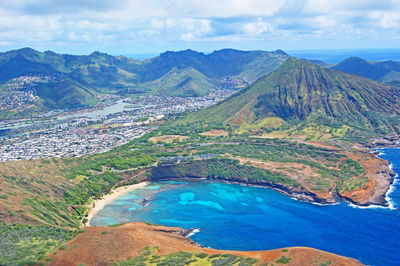 High angle view of river amidst mountains against blue sky