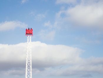 Low angle view of red tower against sky