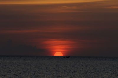 Scenic view of sea against romantic sky at sunset