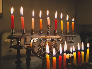 Close-up of lit candles on candlestick holder