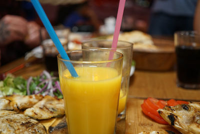 Glass full of fresh squeezed mango smoothie