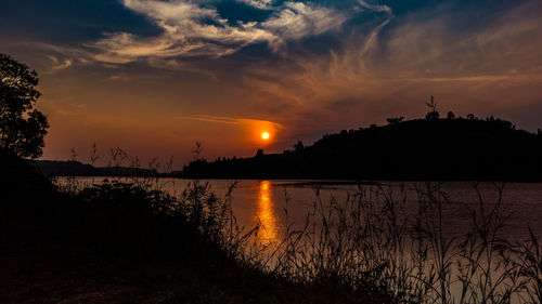 Scenic view of lake against sky during sunset