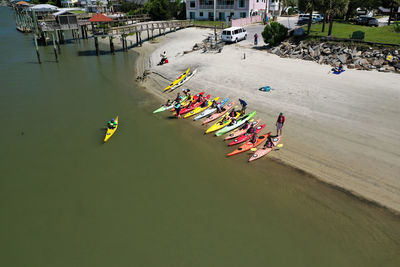 High angle view of people with kayaks at beach