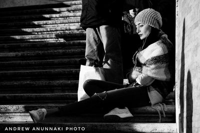 Rear view of couple sitting on staircase