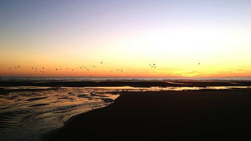 Scenic view of sea against clear sky during sunset