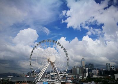 Ferris wheel against buildings in city