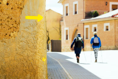 Rear view of people walking on street