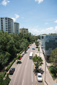 Road by city against sky