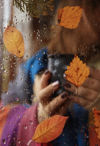 Close-up of wet glass window during rainy season
