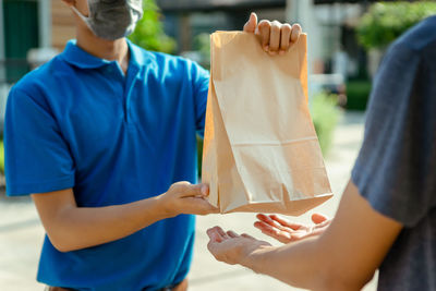 Midsection of couple holding hands