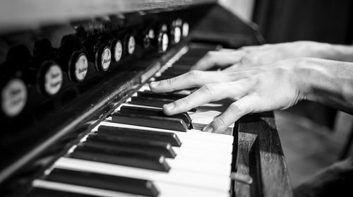 Close-up of hands playing piano