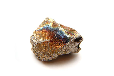 High angle view of multi colored rock on white background