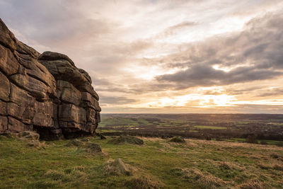 Scenic view of land against sky during sunset