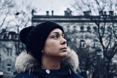 Portrait of young woman looking away during winter