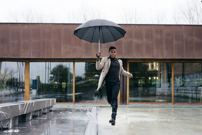 Full length of man with umbrella during winter