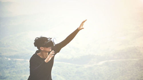 Man wearing virtual reality simulator on mountain