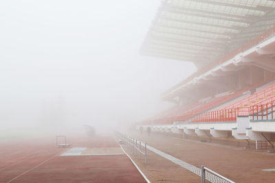 Empty stadium and playing field during foggy weather