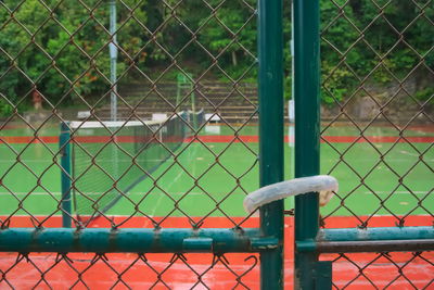 Close-up of chainlink fence against railing