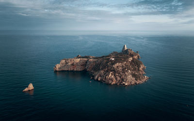 High angle view of rocks in sea against sky