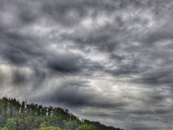 Low angle view of storm clouds over landscape