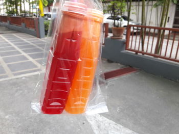 Close-up of orange juice in plastic container