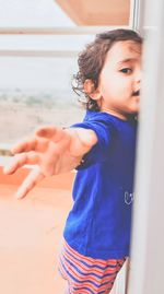 Girl looking away while standing outdoors