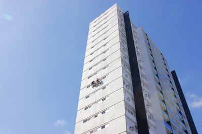 Low angle view of modern building against clear blue sky