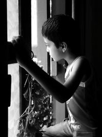 Side view of boy looking at home