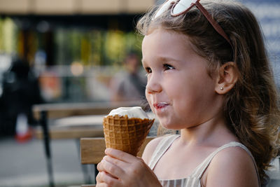 Close-up of young woman holding ice cream cone