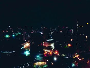 High angle view of illuminated buildings in city at night