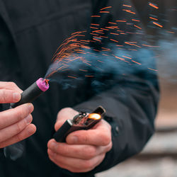 Close-up of hand holding fire