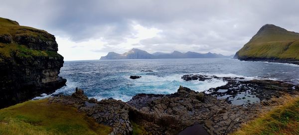 Scenic view of sea and mountains against sky