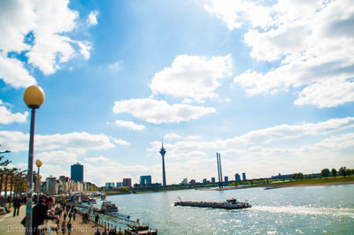 Scenic view of river against sky in city