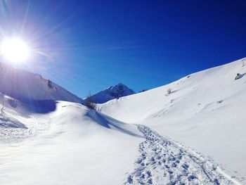 Scenic view of snowcapped mountains against clear blue sky